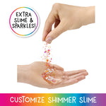 Hand pouring colorful glitter into another hand with 'Extra Slime & Sparkles' text and 'Customize Shimmer Slime' text at the bottom.