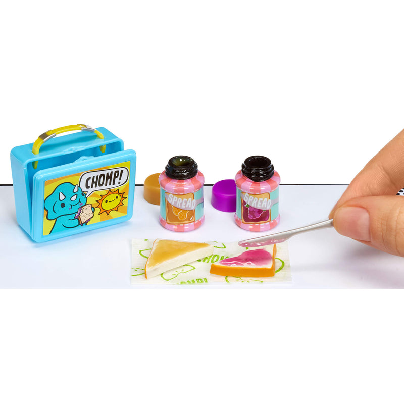 Miniature sandwhich and a small blue lunchbox with 'CHOMP!' on it