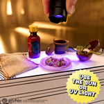 Bottles and a plant under a UV light with a yellow label indicating 'Use the Sun or UV Light'.