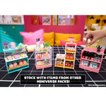 Miniature store sets on a grid surface with a hand interacting with one of them, set against a colorful background.