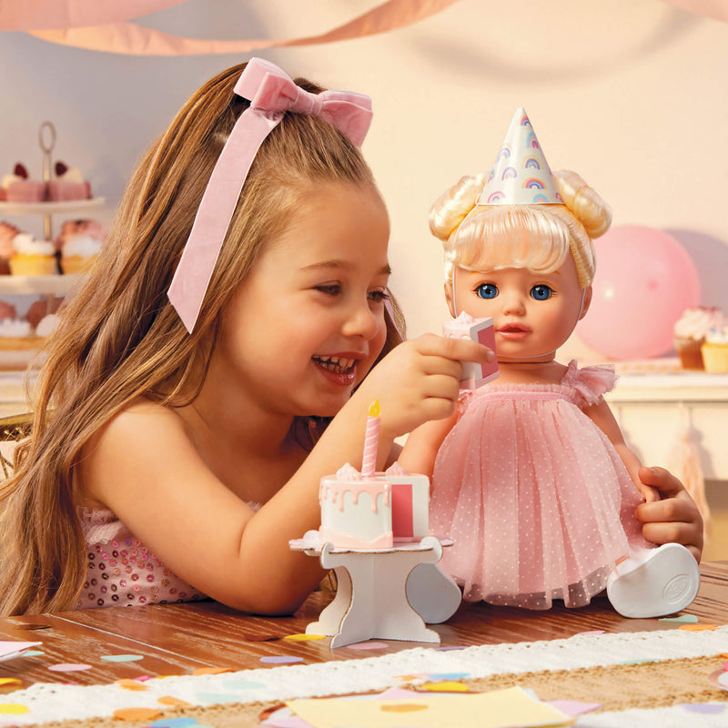 Girl wiping dolls mouth