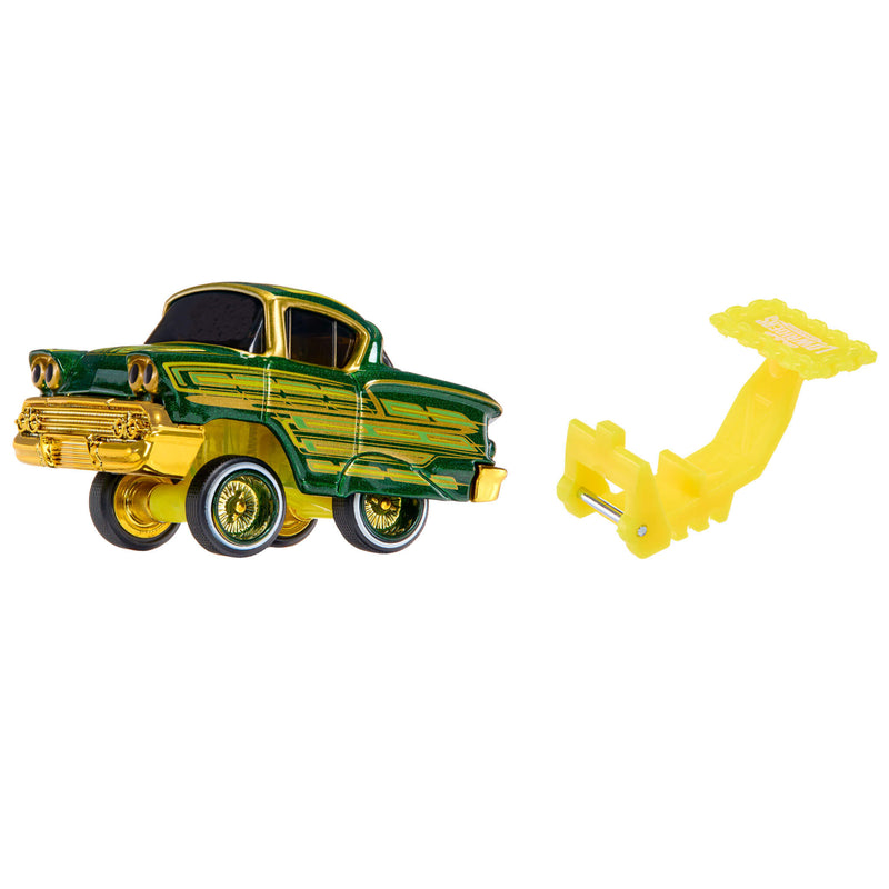 A green and gold toy classic car with black wheels, shown next to a yellow plastic mounting bracket on a plain white background.