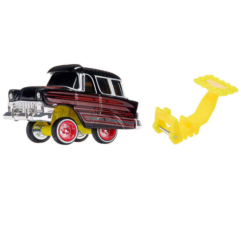 A toy model car with a black and red body, and a separate yellow plastic spoiler attachment, shown on a plain white background.