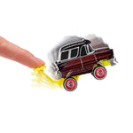 A small toy car with a black and red wood-paneled body, silver trim, and red wheels being pushed by a human finger on a white background.