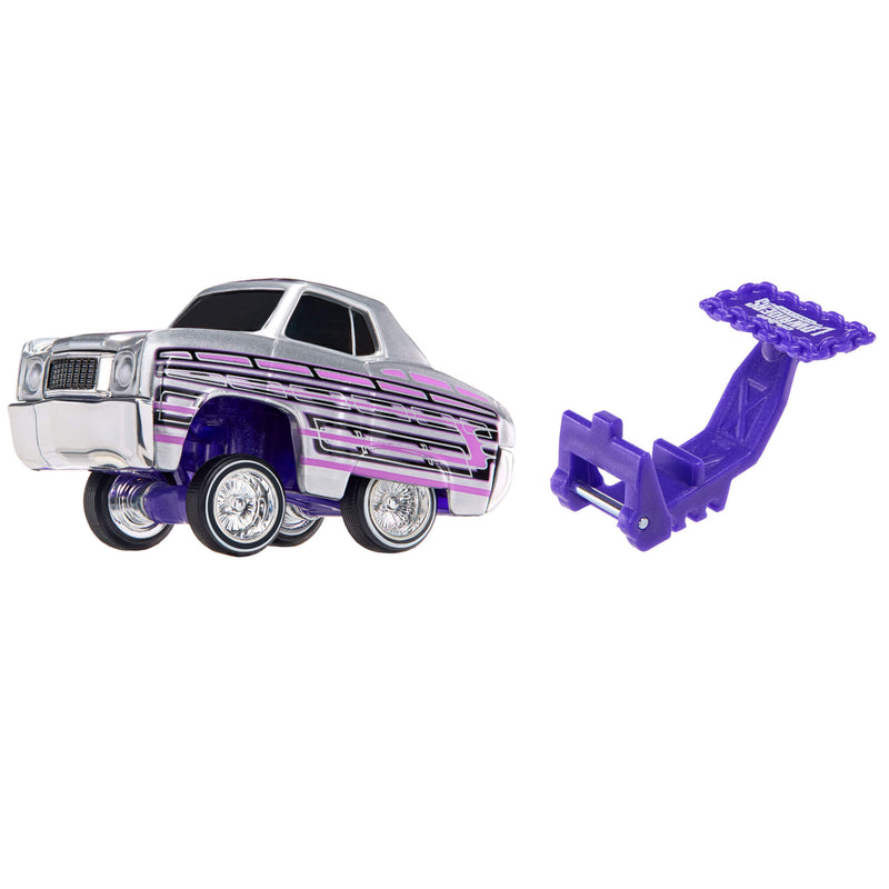 A toy car with a silver body, purple and purple stripes, and a separate purple hitch accessory, shown on a plain white background.