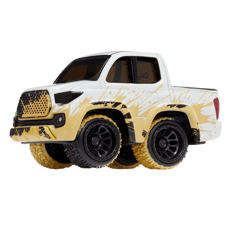 A toy metal truck with a mud splashed look, white body, and black, dirty tires to show a mud look, shown on a plain white background.