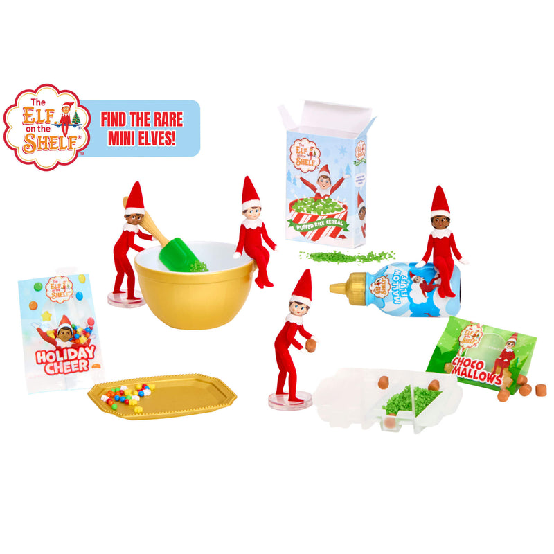 Elf on the Shelf Christmas baking and decorating set with miniature elf figures, a gold mixing bowl, colorful ingredients, gift boxes, and themed accessories on a white background.