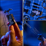 A collage showing a small black handheld toy with a curved blade-like accessory on a cord, held in a human hand, plus close-up views of the item and its parts on a blue grid background.