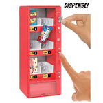 Red toy vending machine with snacks and a hand pressing the 'Dispense!' button.