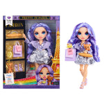 Doll with purple hair and outfit next to its packaging featuring the Eiffel Tower.