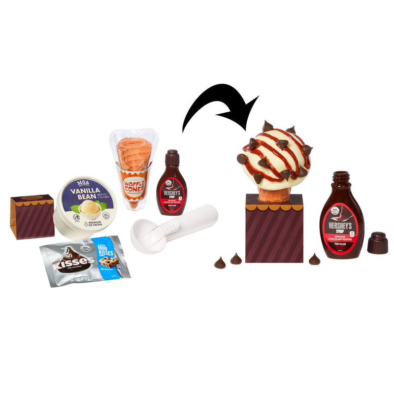 A product kit for recreating a chocolate ice cream cone, featuring Hershey's Kisses, vanilla ice cream, a chocolate sauce bottle, a sugar cone, and other ingredients arranged on a white background with a black arrow pointing to the assembled cone.