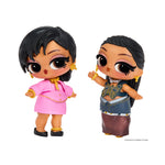 Two small dolls standing - the left doll is wearing a pink dress with black shoes, the right doll has long braided hair, wearing a denim top with a butterfly and a long skirt.