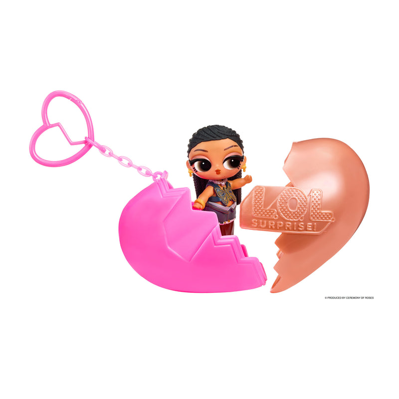Heart keychain shown in two pieces with a small doll in the middle on a white background.