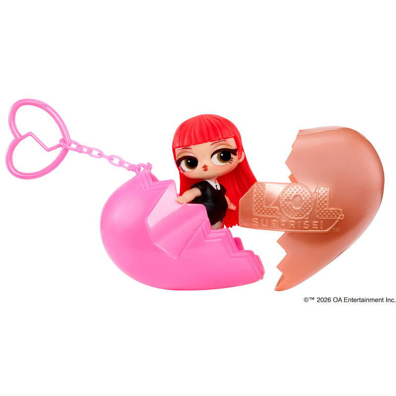 Small doll with heart keychain in to pieces on a white background