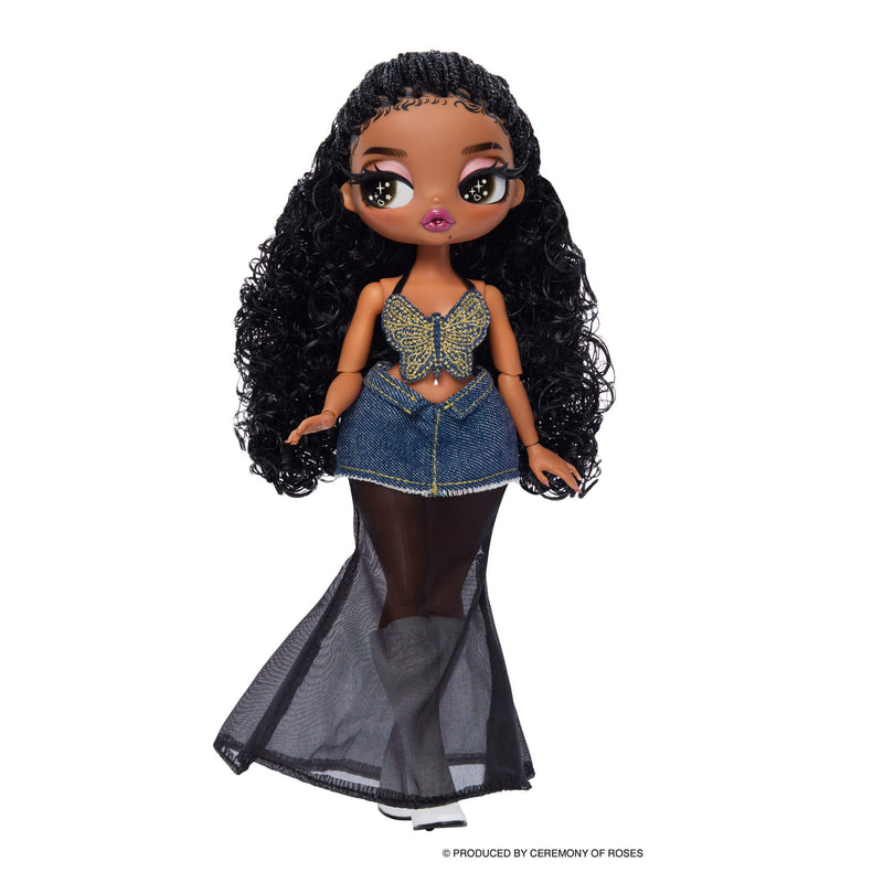 Doll standing straight on, with long curly black hair, butterfly top, denim skirt with sheer lining to the ground, white boots on a white back ground.