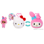 Plush toy transforming from a  white plush with a red bow, then to a pink plush with a blue bow with small doll