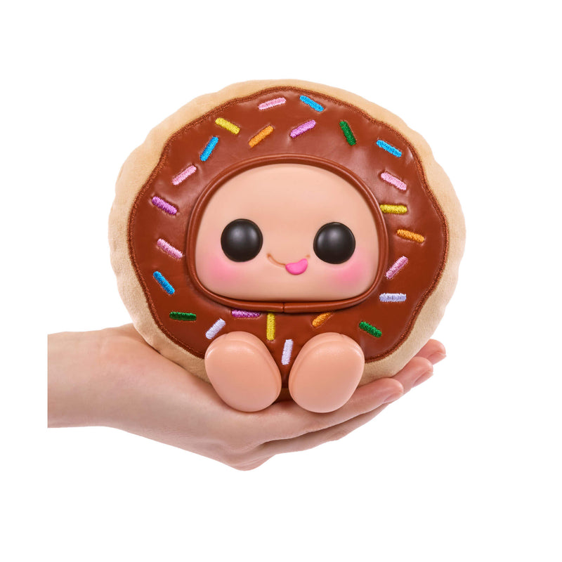 Donut-shaped plush toy with a face held in a hand on a white background