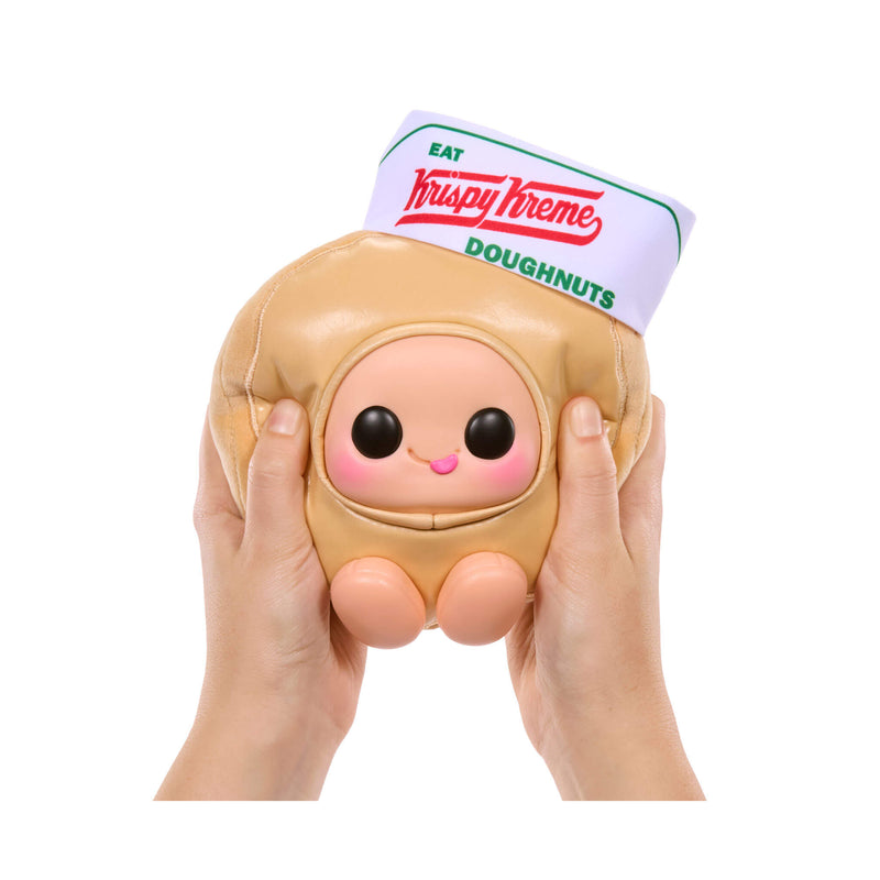 Krispy Kreme donut-shaped squishy toy held by hands on a white background