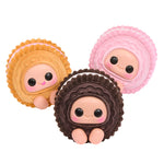 Three cute cookie-shaped figurines with faces on a white background
