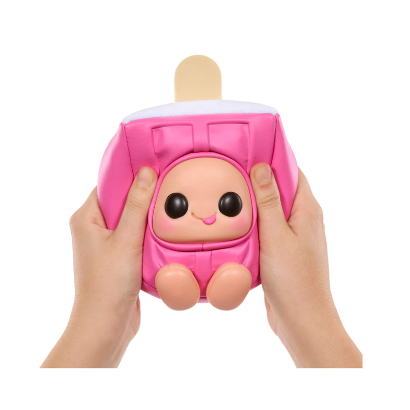 Pink plush toy resembling a popsicle on a stick held by two hands against a white background