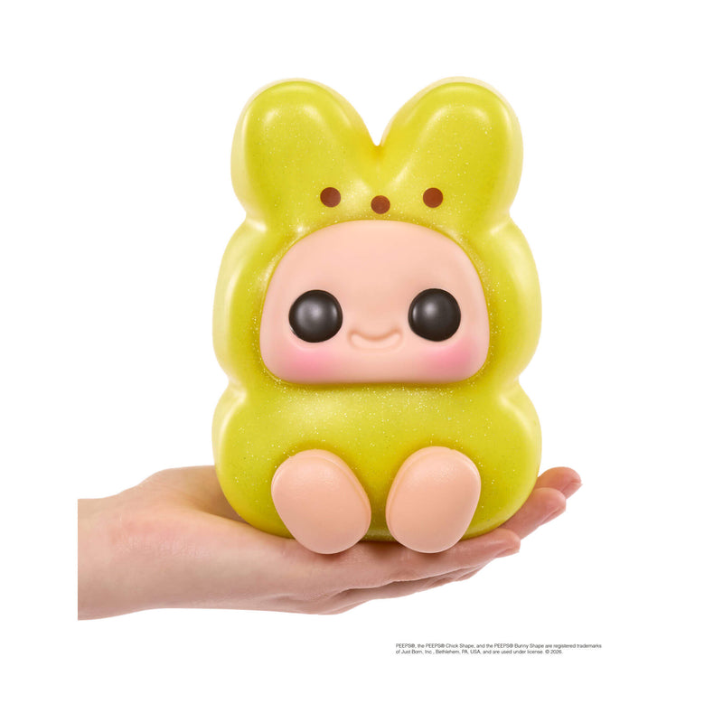 Yellow plush toy with a cute face held in a hand on a white background