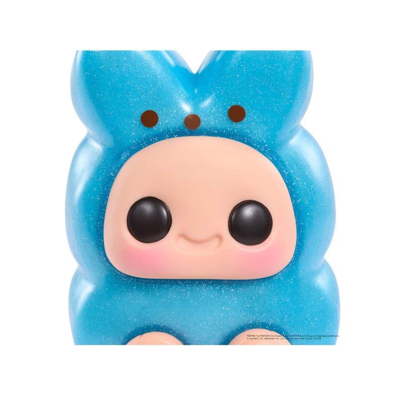 Blue plush toy with a smiling face on a white background