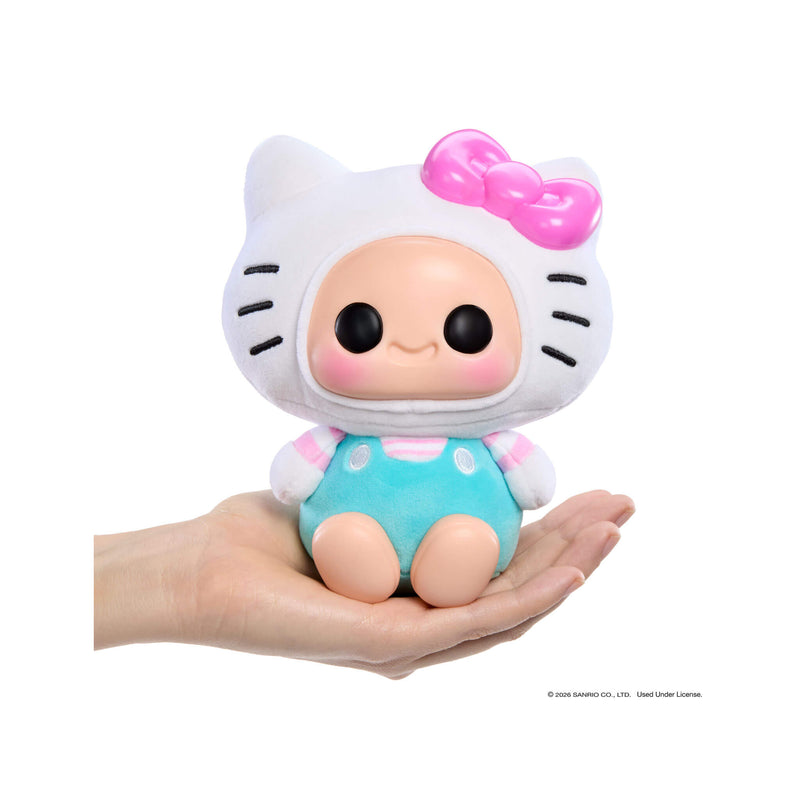 Toy figure with a Hello Kitty design held in a hand on a white background