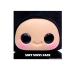 Soft vinyl face figure with black hair on a white background