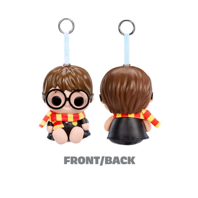 Keychain figure of a character with brown hair, glasses, and a red and yellow scarf on a white background.