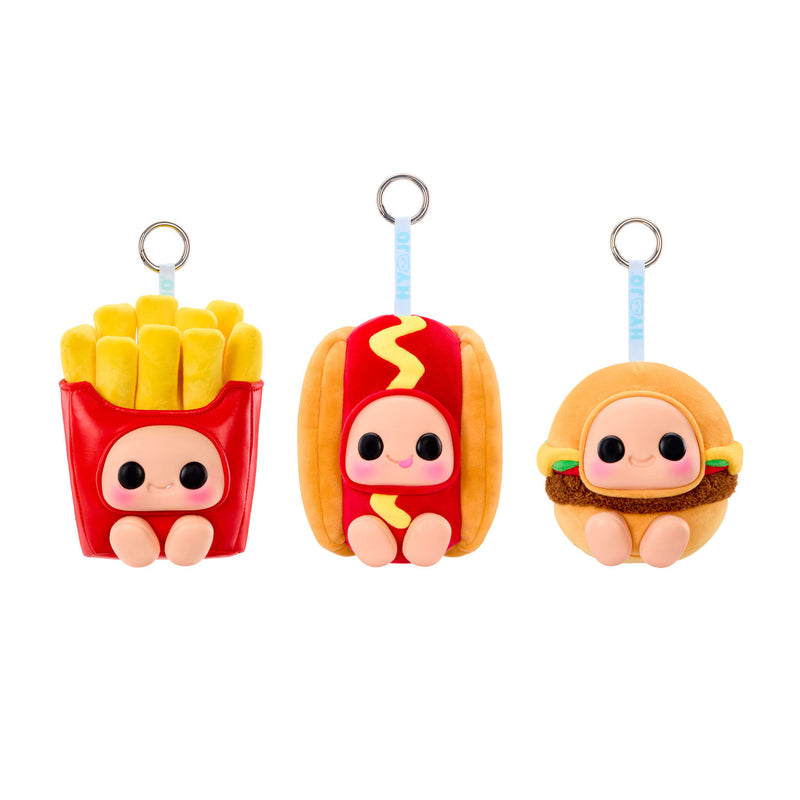 Three keychain food characters- Left side is shaped like a red container of French fries; Center is shaped like a hotdog; Right side is shaped like a hamburger on a white background