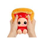 A hands-holding a plush toy shaped like a slice of pizza with brown crust and red looking sauce, featuring a cute cartoon face on the front, with feet, shown against a plain white background.