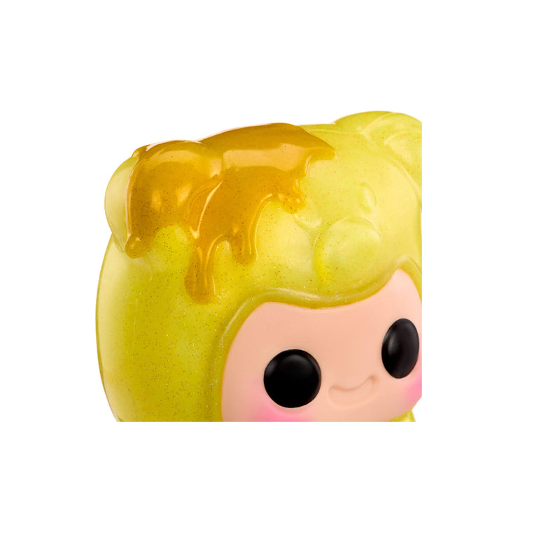 Close up of the yellow gummy, with black eyes, on the left ear a splash of golden yellow on top of the yellow.
