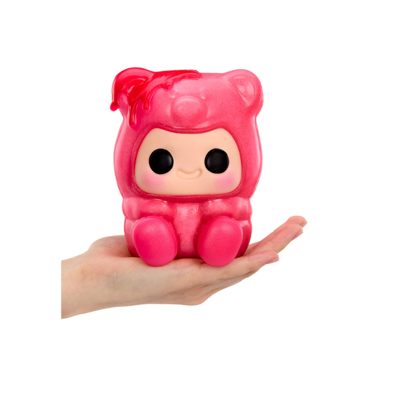 Pink Gummy Bear, with big black eyes, Rosy cheeks, a smile feet being held in the palm of a hand, on a white background