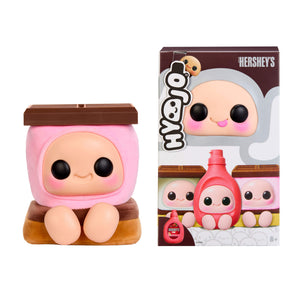 This image shows a product box and a squishy with chocolate bar on top, pink marshmallow with face in the middle,  and two tone brown bottom with feet photographed on a white background.