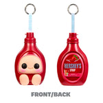 Two Strawberry Syrup bottles shown side by side on a white background, one displaying the front with a cute character face and the other showing the back. Both have metal keyrings. With text 'FRONT /BACK' below.