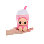 A small pink character toy shaped like a drink cup with a clear dome lid and pink straw, resting on a person's hand against a plain white background.