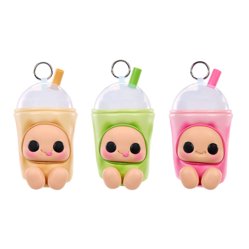 Three cute character keychains shaped like cartoon characters pastel drink cups, shown side by side on a white background. The left one is beige with a beige straw, the middle one is green with a green straw, and the right one is pink with a pink straw.