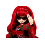A doll with long bright red hair, wearing black sunglasses, a red and dark green striped knit sweater, posed against a plain white background.