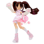 A fashion doll with long brown pigtails, wearing a pink and white outfit with fluffy paw-print gloves, a pink bag, and pink boots, posed against a plain white background.