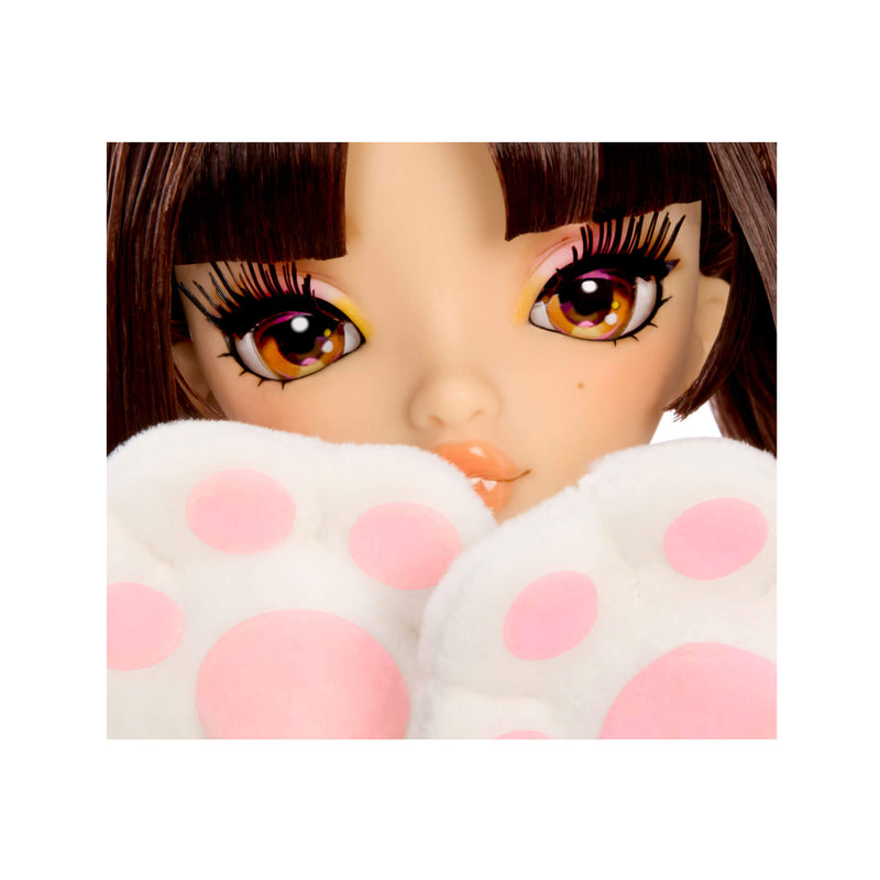 Close-up of a doll's face with brown hair and large brown eyes, partially covered by white plush paw-shaped props with pink polka dots.