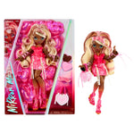 Mirror Mi doll with long blonde hair, a pink dress, and pink accessories, shown both inside its retail packaging and standing outside it on a white background.
