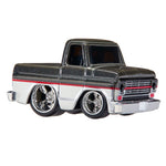 A die-cast toy model of a classic pickup truck with a black glitter finish, chrome wheels, and a red stripe detail, shown on a plain white background.