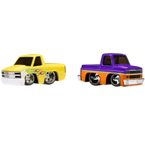 Two  die-cast toy pickup trucks on a plain white background. The truck on the left is bright yellow with a white front bumper and black wheels.