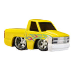 A yellow  die-cast toy pickup truck with a white front bumper and grille, chrome wheels, and a blue and red flame graphic on the side, shown against a plain white background.