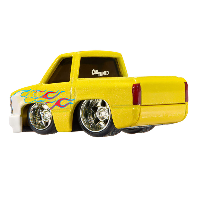 A yellow die-cast toy pickup truck with custom flame decals on the side, chrome wheels, and a 'CAR TUNED' decal on the rear window, shown against a plain white background.