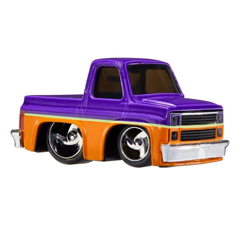 A die-cast toy pickup truck with a glossy purple cab and bed, an orange lower body, a thin yellow stripe, and chrome wheels, isolated on a white background.