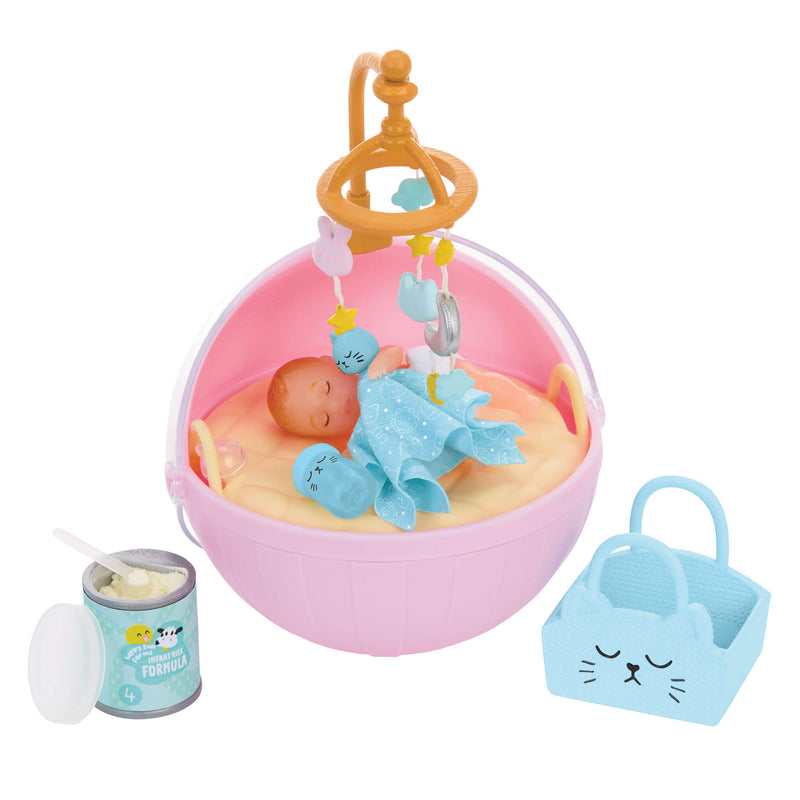 Mini baby sleeping in ball uses as a bed with accessories on a white background
