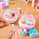 Mini Toy baby crib with baby dolls and accessories on a wooden surface