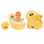 Mini baby in mini bath tub with accessories on a white background