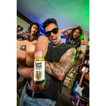 Person holding a 'Liquid Death' mini bottle with a colorful background